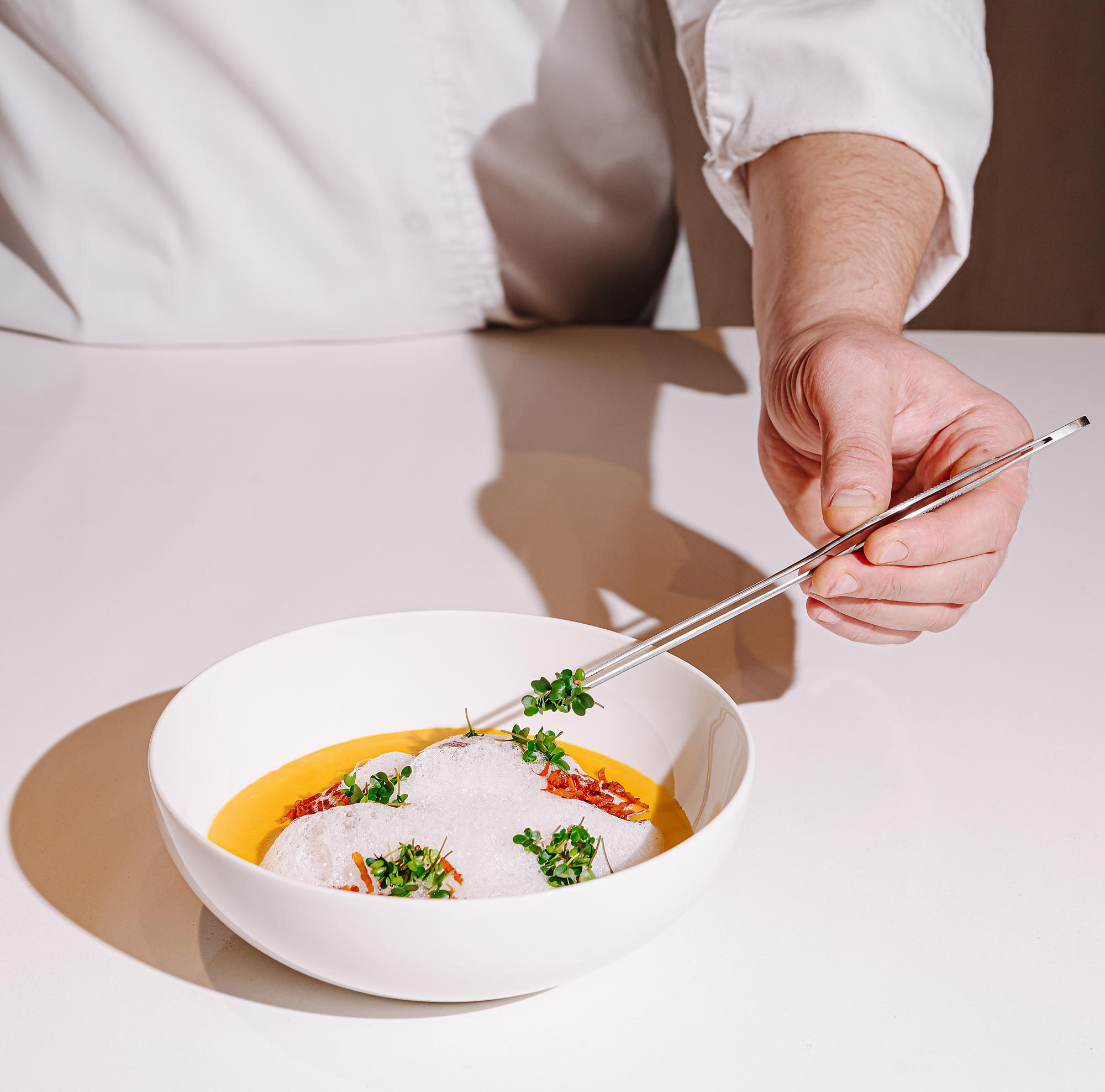Chef arranging a simple plated dish